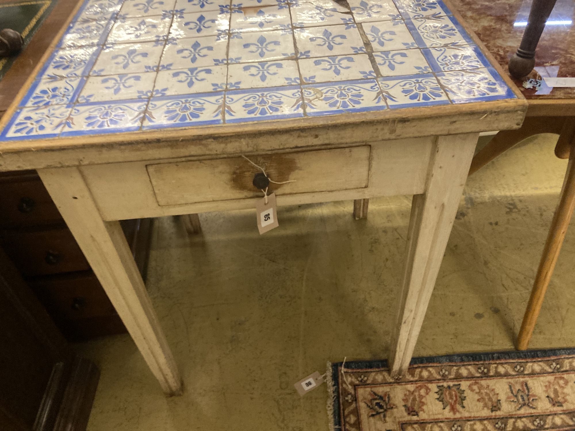 A Continental painted tile top table, width 71cm depth 70cm height 78cm